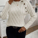 Clara – Pull en maille torsadée avec détails de boutons 